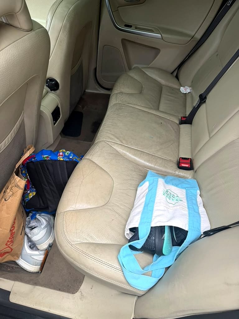 Back seat before the detail, dirty and cluttered