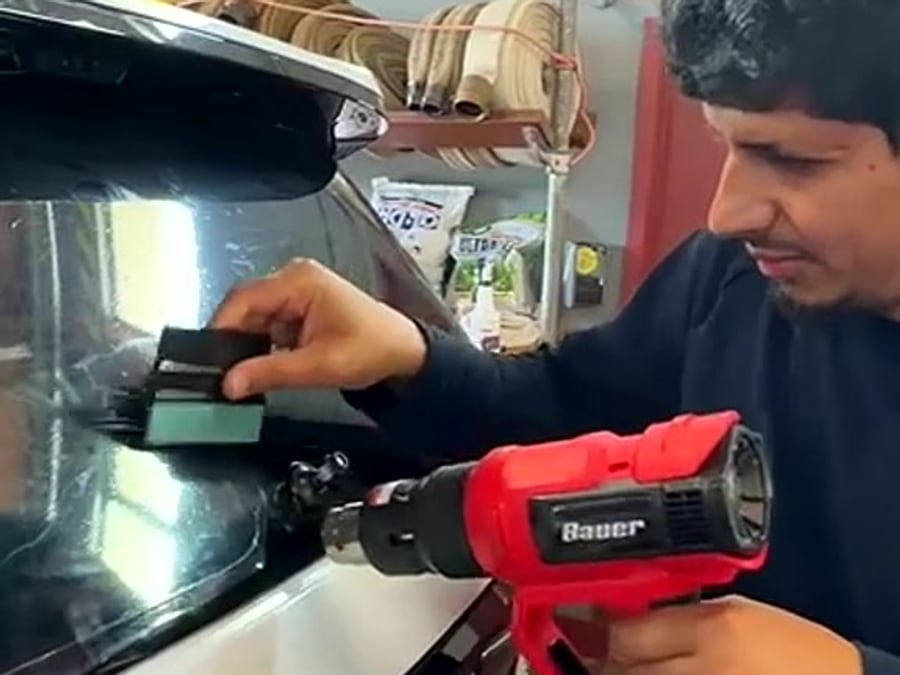 Eco Car Detail technician installing window tint