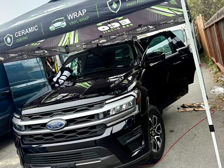 Black Ford Expedition under the Eco Car Detail wrap and PPF tent