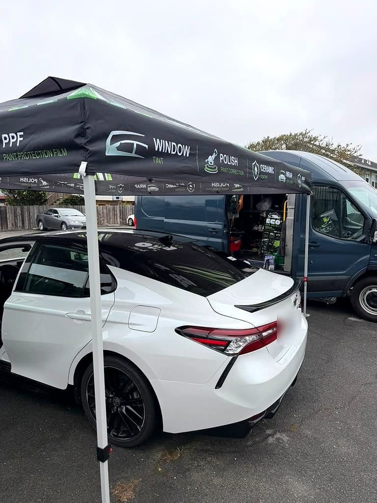 White Toyota Camry under the Eco Car Detail tent