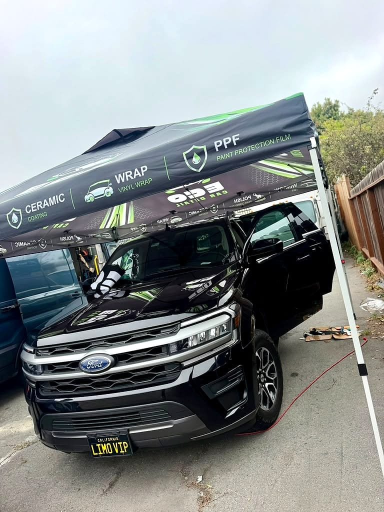 Black Ford Expedition under the Eco Car Detail tent